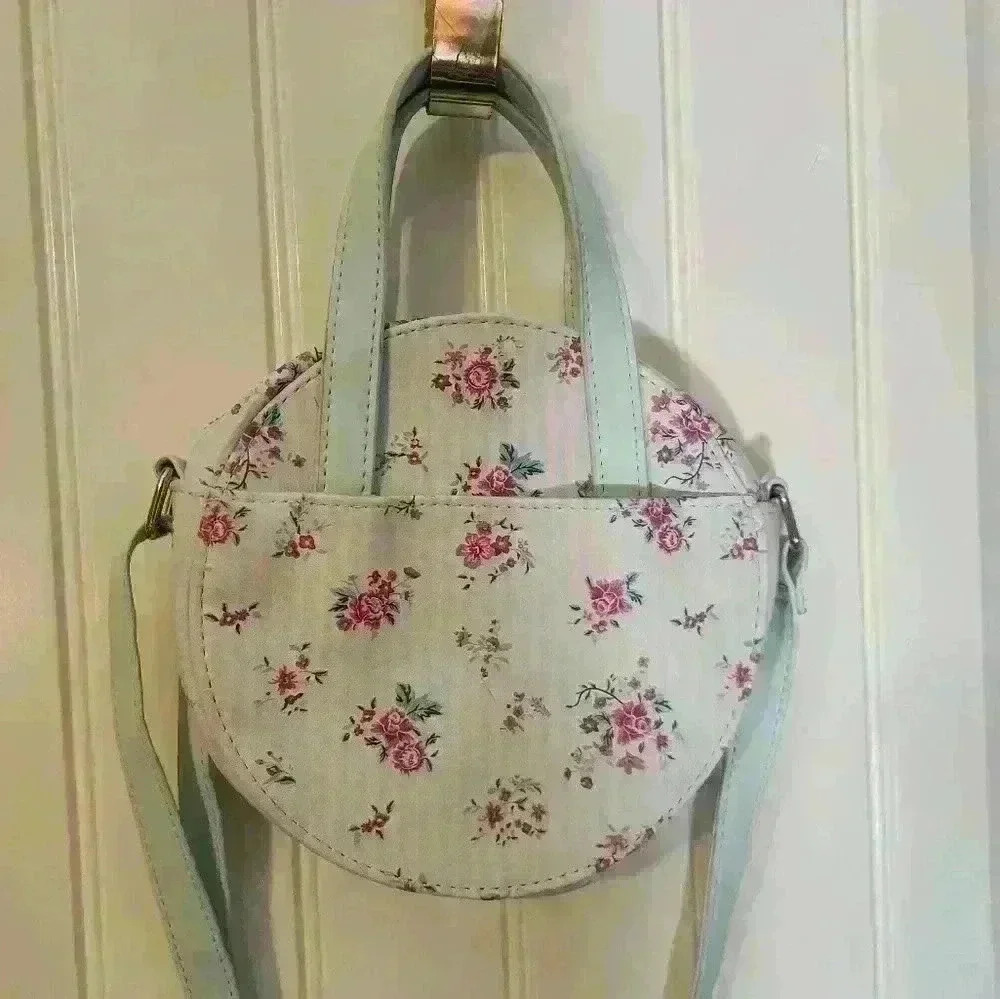 Mint green with detail silk lining.Round Purse with over shoulder and hand strap